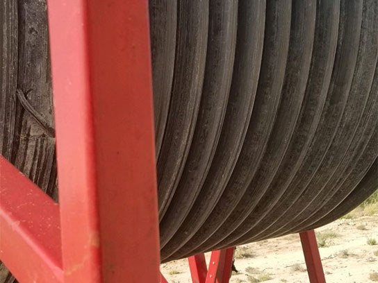 Wrapped poly tubing on a red container.